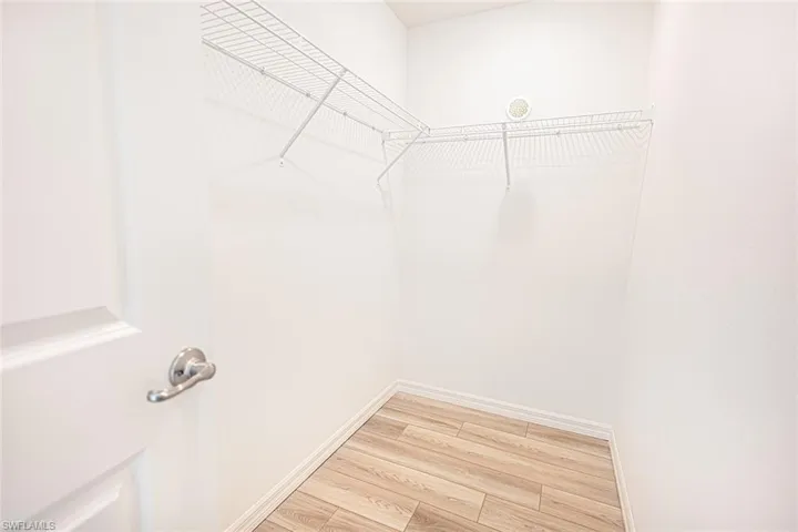 Walk in closet featuring light wood-type flooring