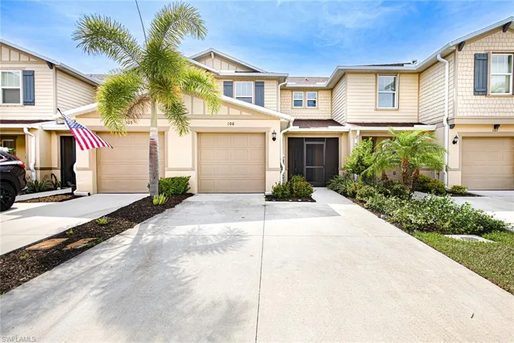 View of property featuring concrete driveway and a garage
