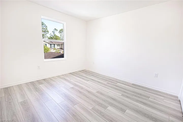 Unfurnished room featuring light wood-style flooring and baseboards