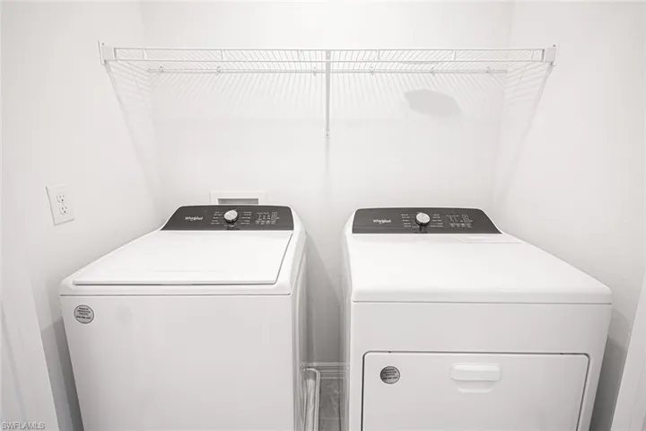 Laundry area featuring independent washer and dryer and laundry area