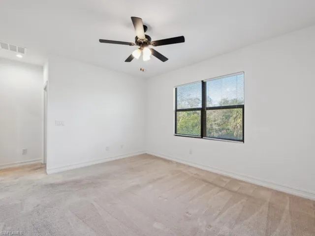Spare room with light colored carpet and ceiling fan