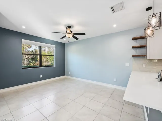Spare room featuring light tile patterned floors and ceiling fan