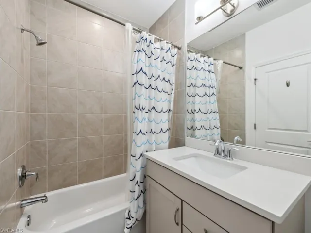 Bathroom with vanity and shower / tub combo