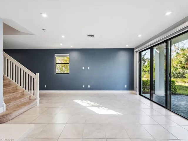 Unfurnished room featuring light tile patterned floors and a wealth of natural light