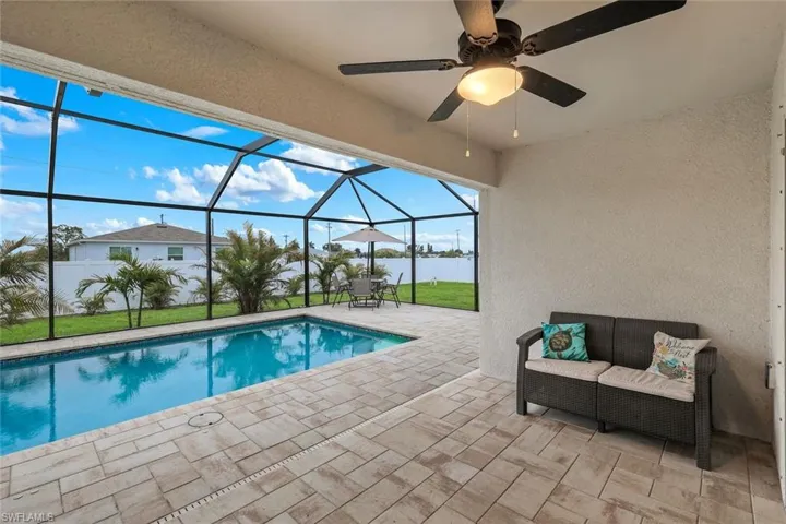 Outdoor pool featuring a patio, a sunroom, and a lanai