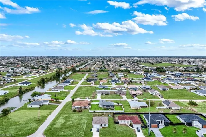 Aerial perspective of suburban area with a large body of water