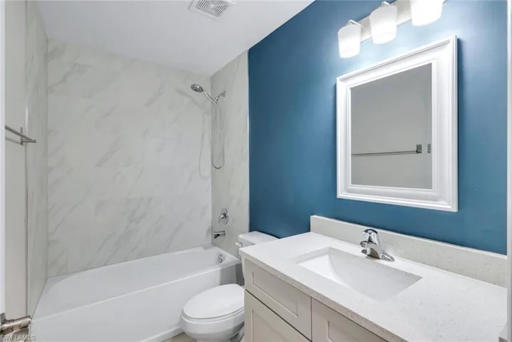 Bathroom featuring vanity and  shower combination