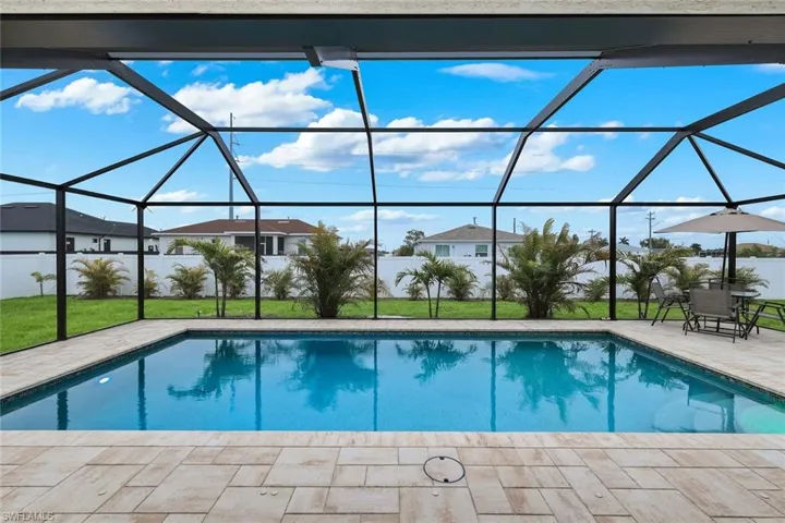 Outdoor pool with a sunroom, a lanai, and a patio area