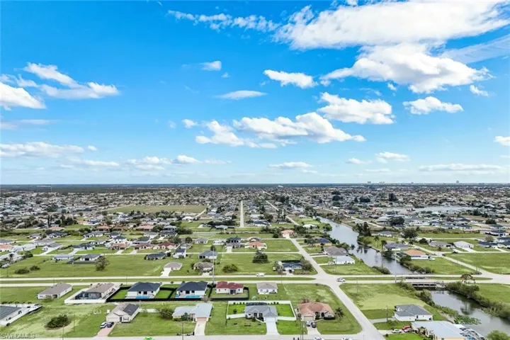 Aerial perspective of suburban area with a nearby body of water