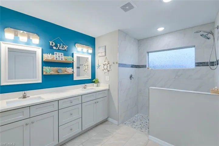 Full bath with double vanity and walk in shower