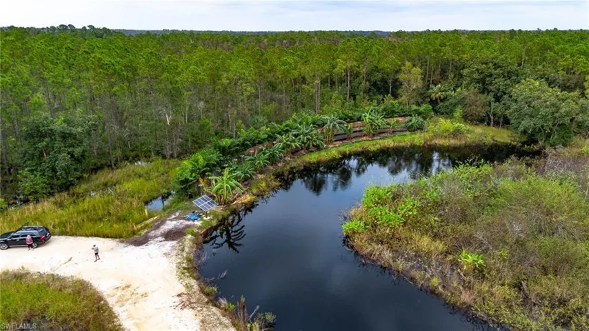 Birds eye view of property with a water view