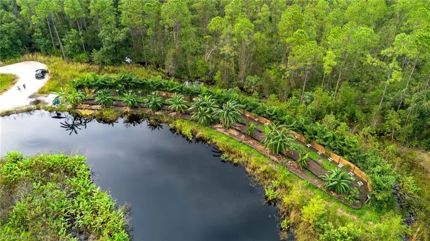 Birds eye view of property with a water view