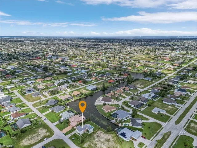Aerial view of property's location with nearby suburban area