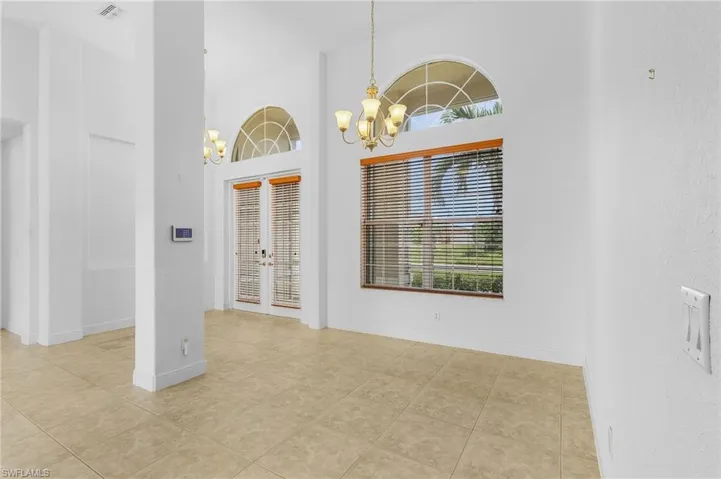 Dinning area featuring a chandelier and french doors