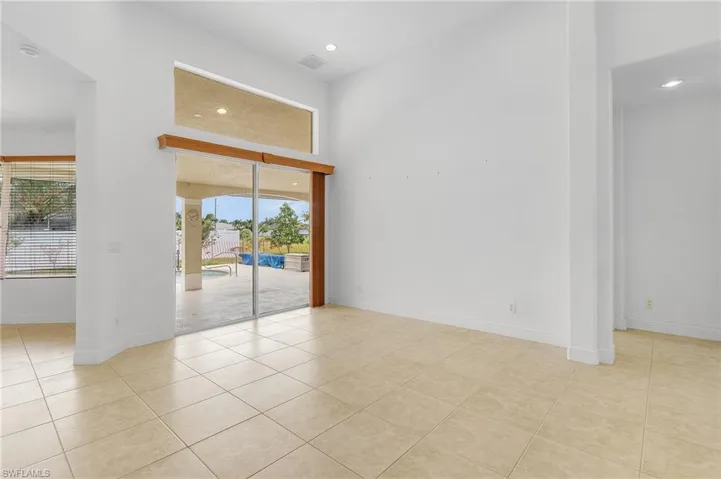 Formal living room with light tile patterned floors