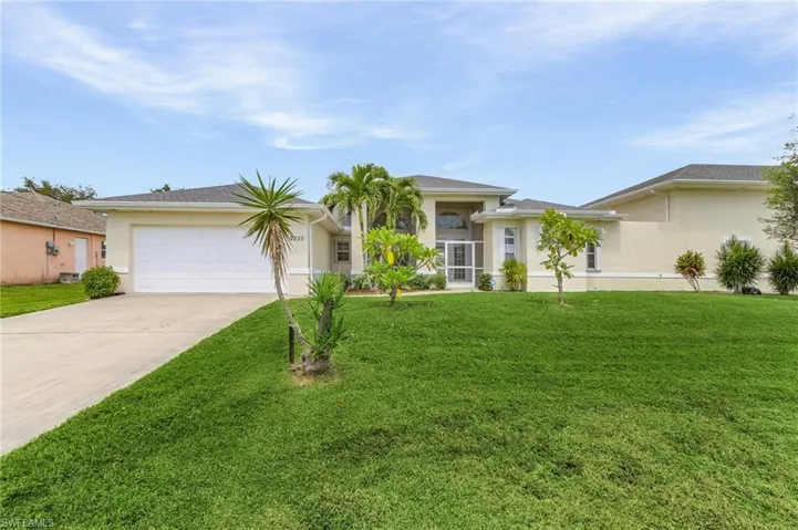 Single story home featuring a garage and a front yard
