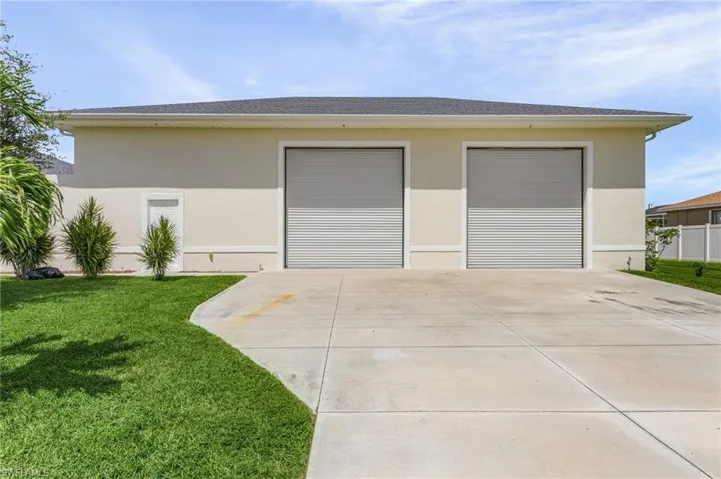 View of front of detached garage featuring 2 rolling doors.