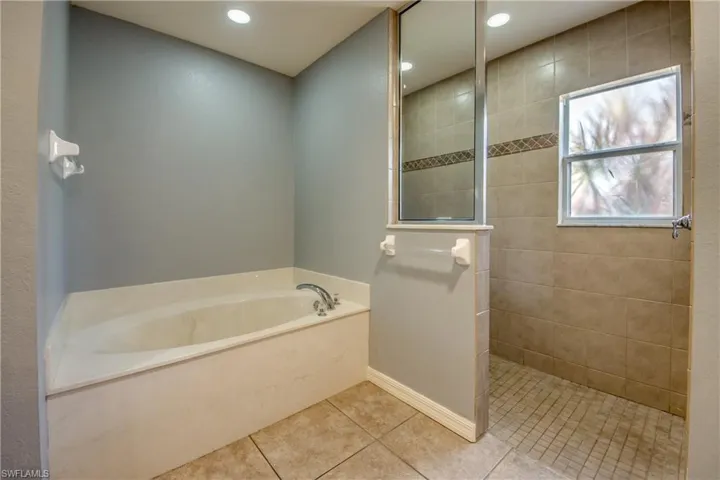 Full bathroom featuring a garden tub, tile patterned flooring, walk in shower, and recessed lighting