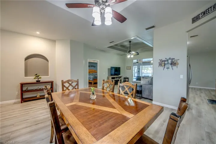 Dining area with a ceiling fan, wood finished floors, and recessed lighting