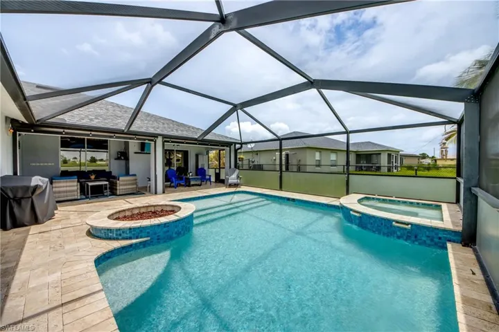 View of pool with a patio, a pool with connected hot tub, grilling area, an outdoor living space, and glass enclosure