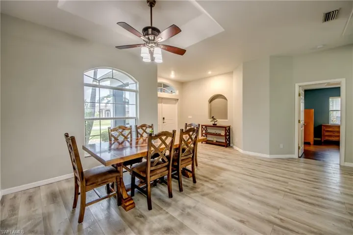 Dining room with light wood finished floors and a ceiling fan