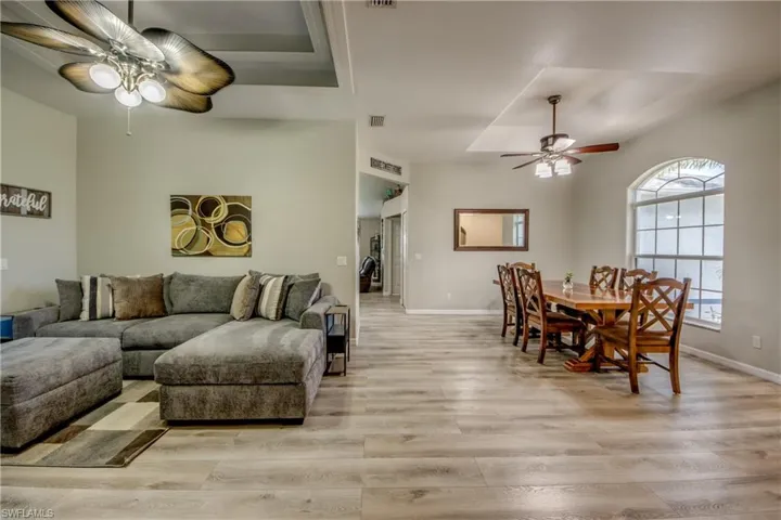Living area featuring a ceiling fan and light wood-type flooring