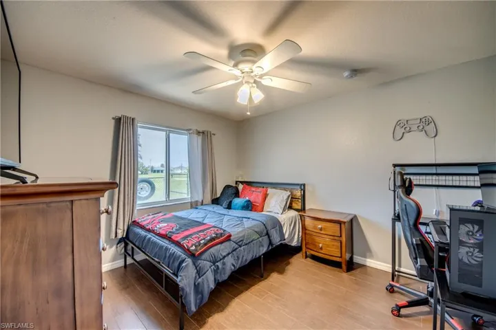 Bedroom featuring wood finished floors and ceiling fan