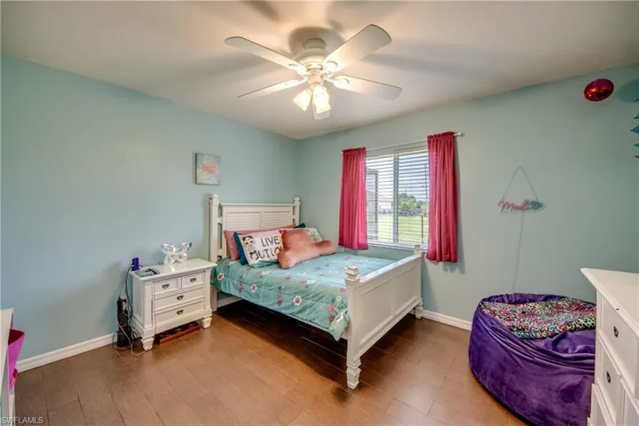 Bedroom featuring wood finished floors and a ceiling fan