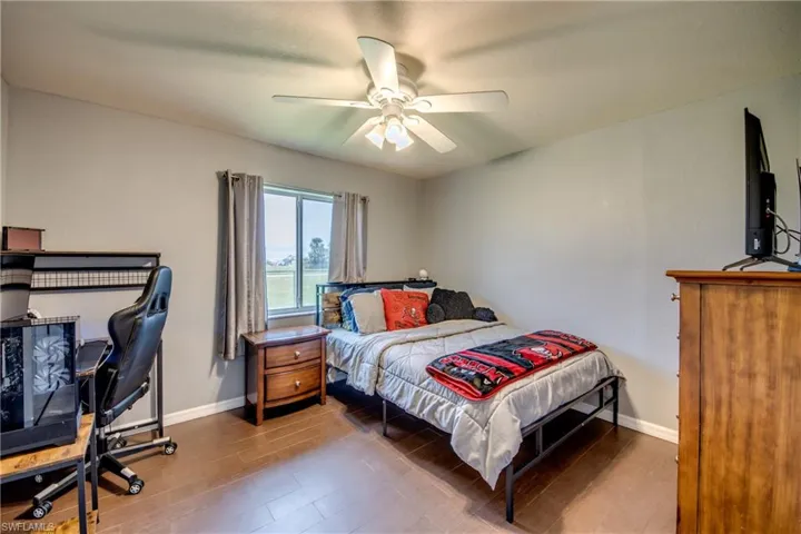 Bedroom with wood finished floors and ceiling fan