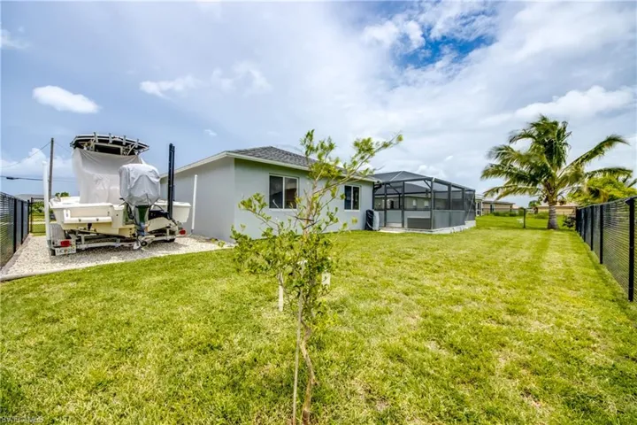 Rear view of house with stucco siding and glass enclosure