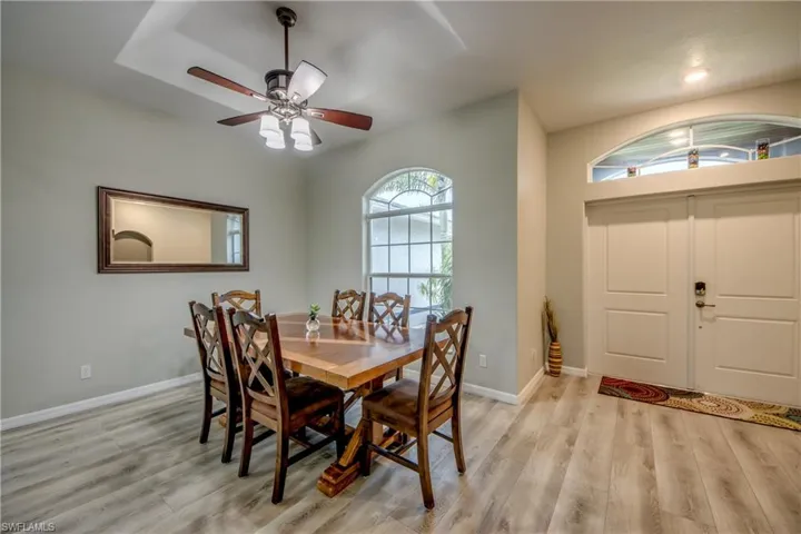 Dining area featuring light wood-type flooring, ceiling fan, and recessed lighting
