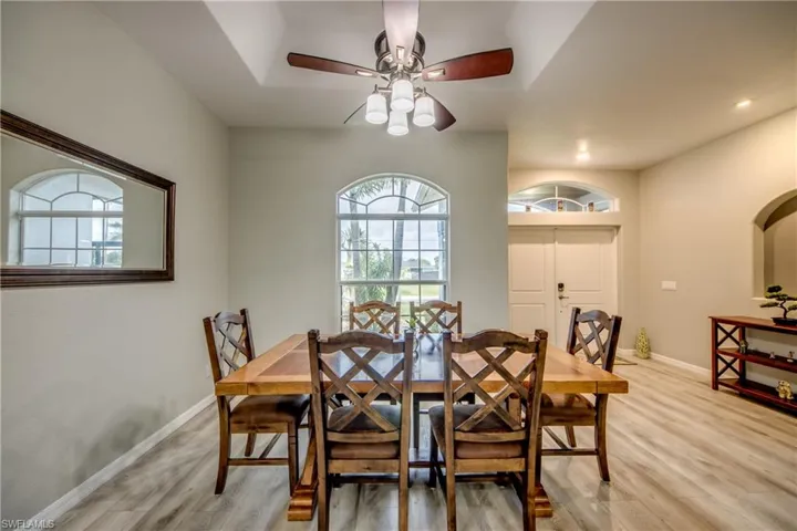 Dining space featuring light wood-style flooring, a ceiling fan, and recessed lighting