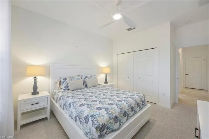 Bedroom featuring light colored carpet and ceiling fan and Queen size bed