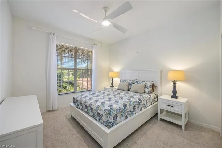 Bedroom featuring light colored carpet and ceiling fan and Queen size bed