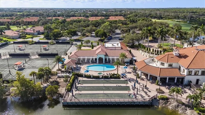 Drone / aerial view of a nearby body of water and a pool