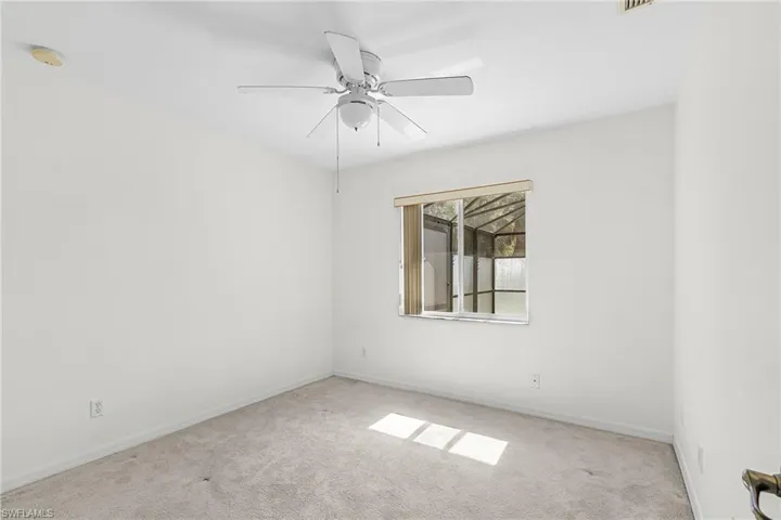 Empty room featuring carpet and ceiling fan