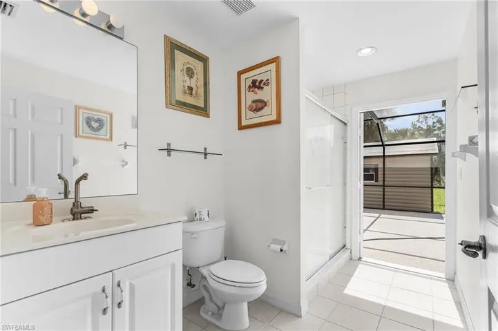 Bathroom with vanity, light tile patterned floors, a shower stall, and recessed lighting