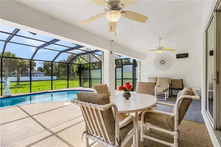Outdoor pool featuring a patio area, a lanai, a sunroom, and a ceiling fan
