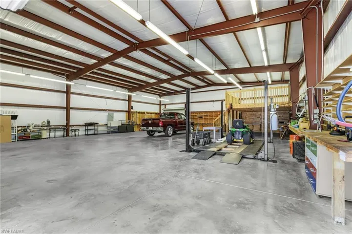 Garage featuring metal wall and a workshop area