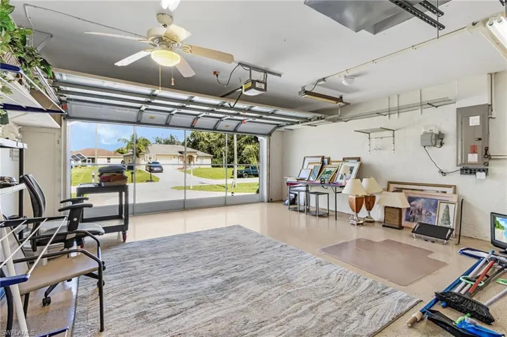 Garage featuring electric panel and a garage door opener