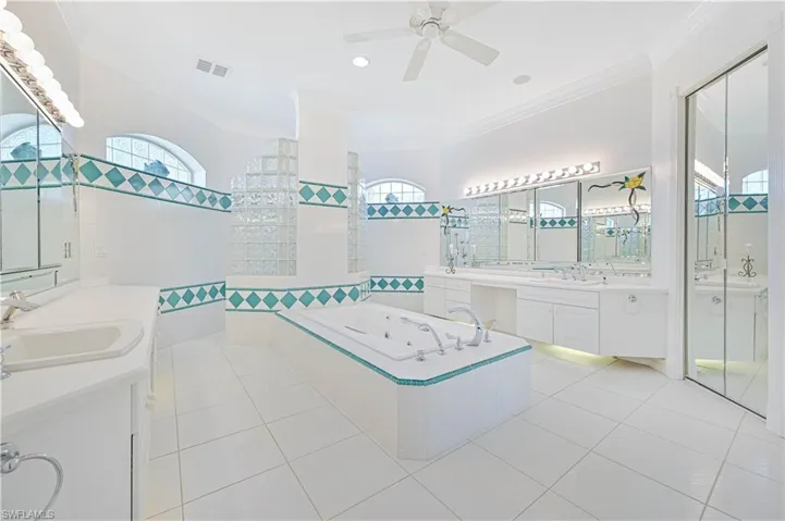 Primary bathroom with double vanities, jetted tub