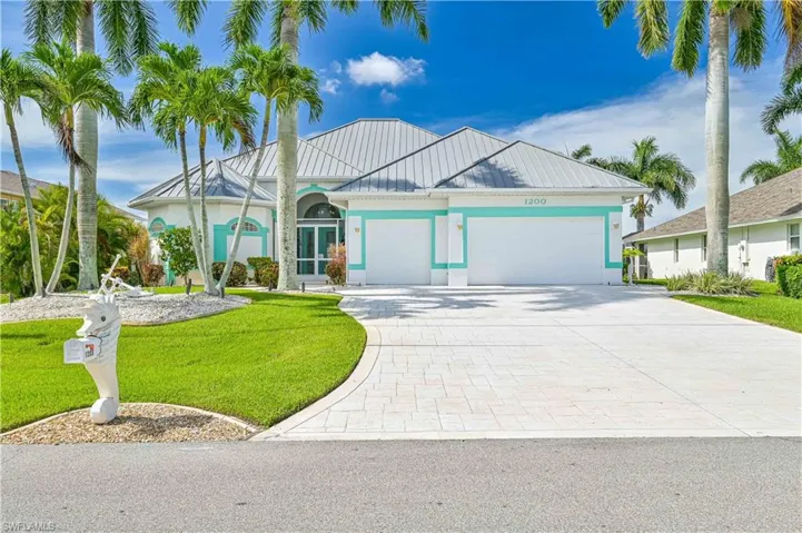 Front of home, 3 car garage, metal roof