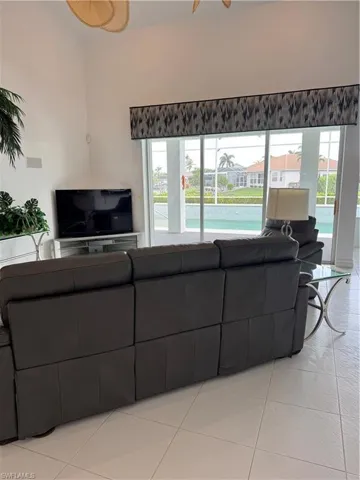 Living area featuring light tile patterned floors and a wealth of natural light