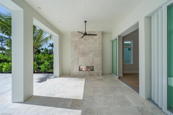 The pool deck features marble pavers, natural gas fireplace, outdoor kitchen, covered and uncovered areas, and pool with flush spa. Greenery has been planted along the rear and side property fence and will mature over the next several months. The openings have been pre-wired for optional roll-down bug and/or storm screens.