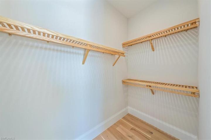 Bedroom 4 in the Dune plan is dubbed the Jr. Primary, with sliders out to the pool and a large en-suite with direct pool deck access, and large walk-in closet.