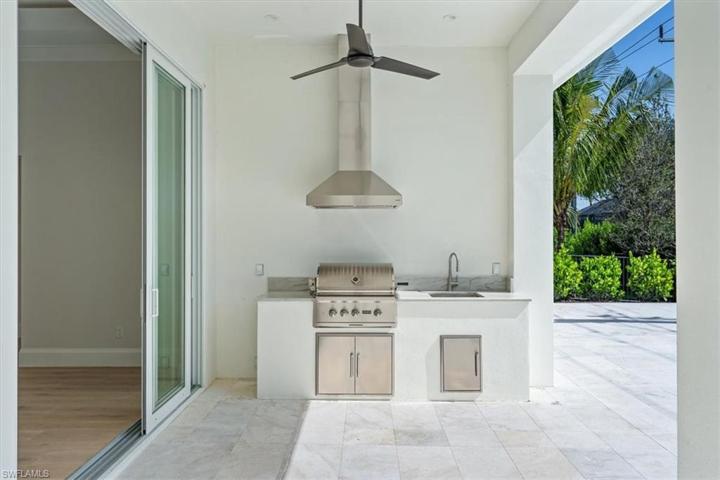 The pool deck features marble pavers, natural gas fireplace, outdoor kitchen, covered and uncovered areas, and pool with flush spa. Greenery has been planted along the rear and side property fence and will mature over the next several months. The openings have been pre-wired for optional roll-down bug and/or storm screens.