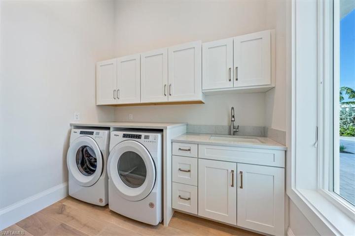 The light and bright laundry room is located just off of the garage with a large window overlooking the front of the home.