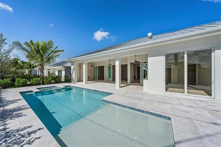 The pool deck features marble pavers, natural gas fireplace, outdoor kitchen, covered and uncovered areas, and pool with flush spa. Greenery has been planted along the rear and side property fence and will mature over the next several months. The openings have been pre-wired for optional roll-down bug and/or storm screens.