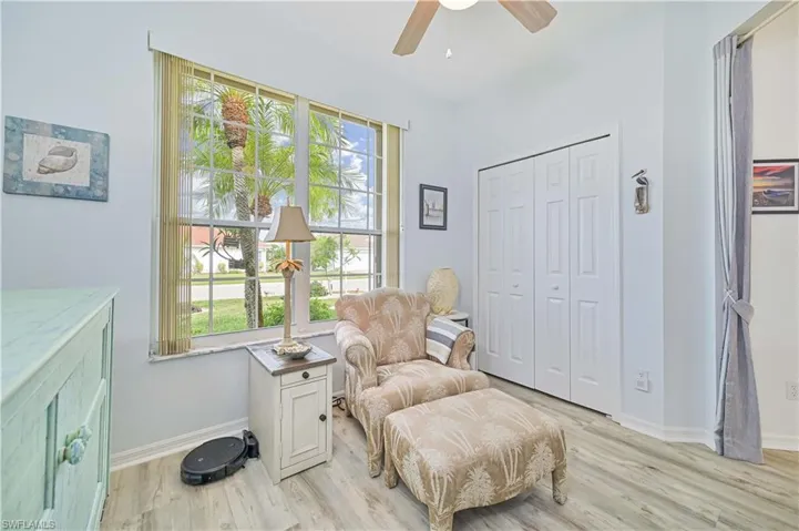 Sitting room featuring ceiling fan, plenty of natural light, and light wood-type flooring