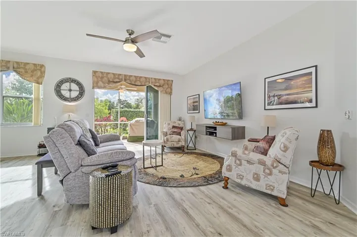 Living room featuring light wood-type flooring and ceiling fan